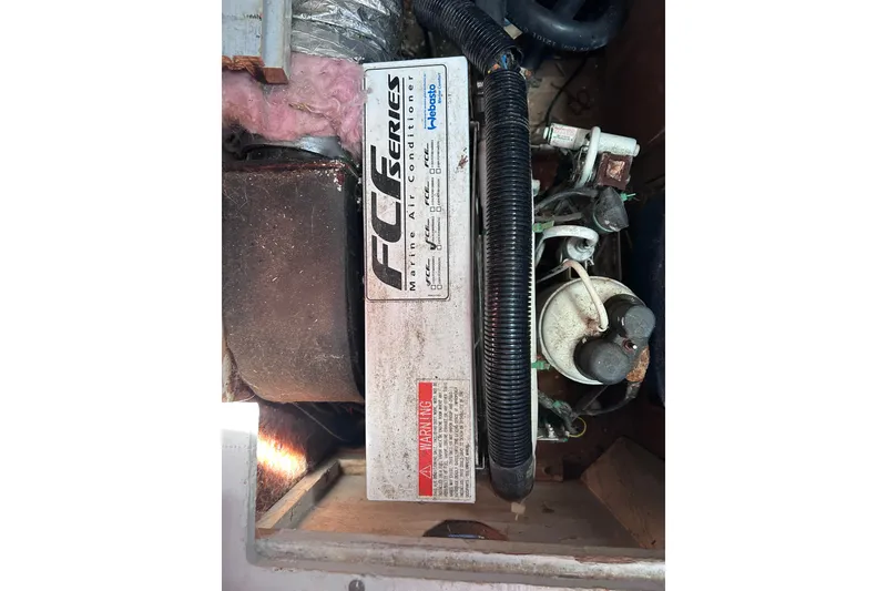 Slide: The Image of Marine air conditioner in a 1979 Tartan 37 sailboat engine compartment. - 57