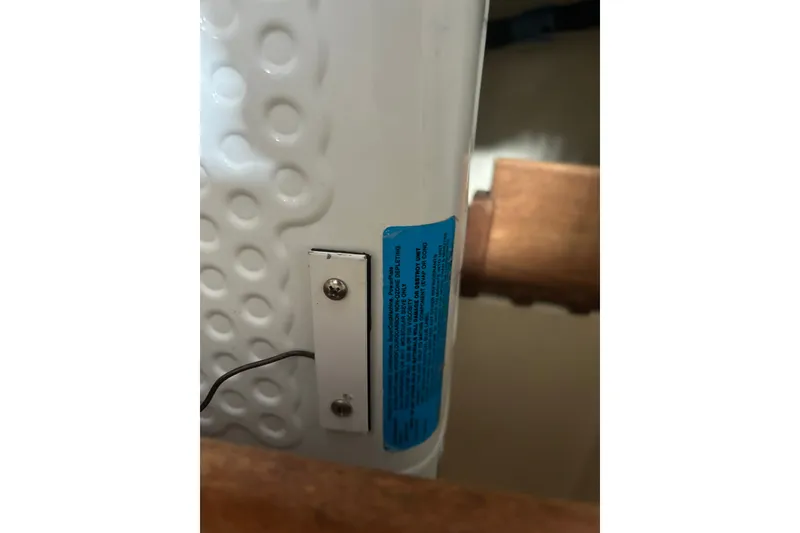 Slide: The Image of Close-up of a 1979 Tartan 37 interior detail with textured surface and blue label. - 39
