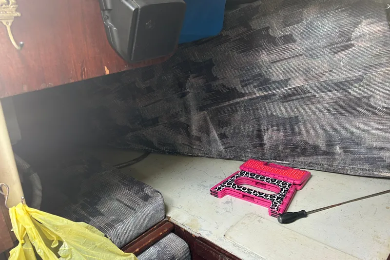 Slide: The Image of Interior of a 1979 Tartan 37 sailboat with a pink step stool and patterned cushions. - 20