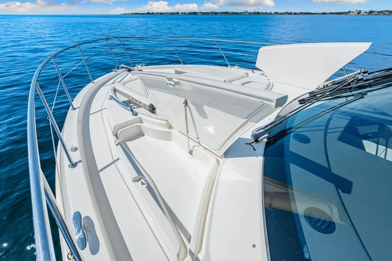 Slide: The Image of 2024 Riviera 4600 Sport Yacht Platinum Edition on calm blue waters. - 34
