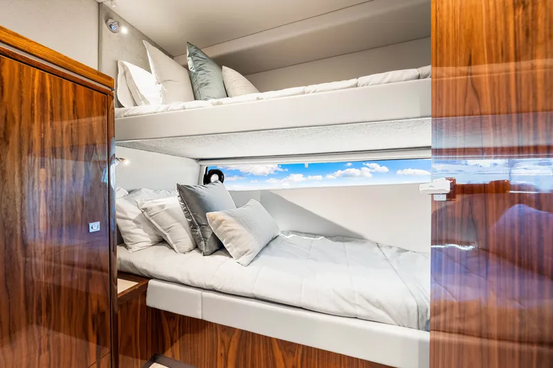 Slide: The Image of Luxurious cabin interior of 2024 Riviera 4600 Sport Yacht Platinum Edition with bunk beds. - 66