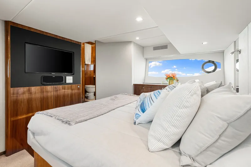 Slide: The Image of Luxurious bedroom interior of 2024 Riviera 4600 Sport Yacht Platinum Edition with modern amenities. - 59