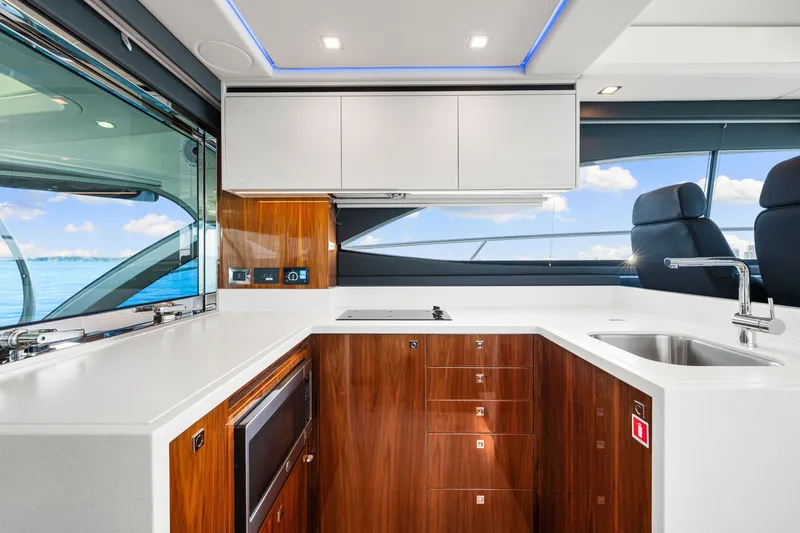 Slide: The Image of Luxurious interior of 2024 Riviera 4600 Sport Yacht Platinum Edition with modern kitchen design. - 45