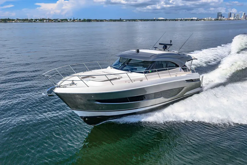 Slide: The Image of 2024 Riviera 4600 Sport Yacht Platinum Edition cruising on open water. - 15