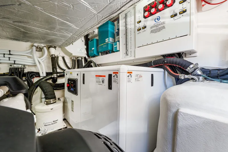 Slide: The Image of Engine room of 2024 Riviera 4600 Sport Yacht Platinum Edition, showcasing electrical systems and components. - 70