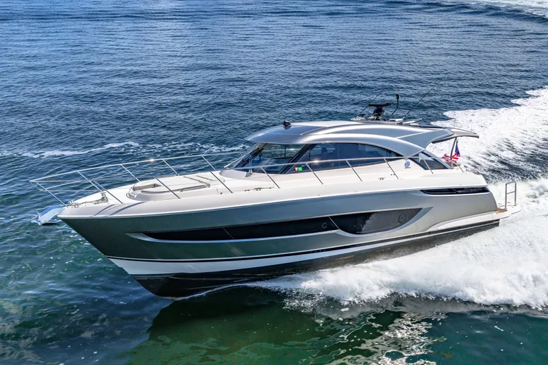 Slide: The Image of 2024 Riviera 4600 Sport Yacht Platinum Edition cruising on open water. - 20