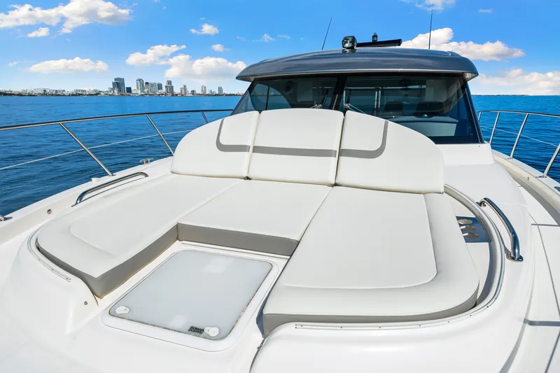 Slide: The Image of 2024 Riviera 4600 Sport Yacht Platinum Edition with luxurious sunbed on deck, ocean view. - 36