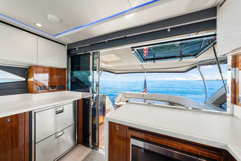 Slide: The Image of Luxurious interior of 2024 Riviera 4600 Sport Yacht Platinum Edition with ocean view. - 44