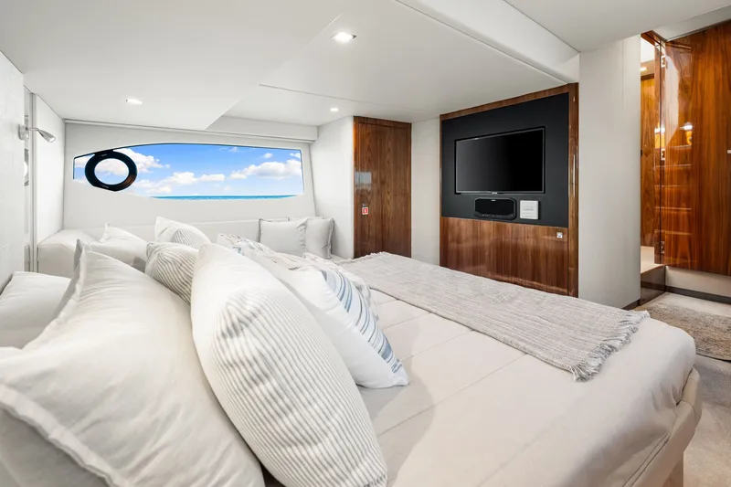Slide: The Image of Luxurious bedroom interior of 2024 Riviera 4600 Sport Yacht Platinum Edition with ocean view. - 61