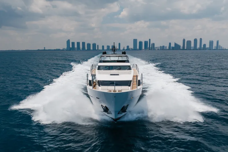 Slide: The Image of 2024 Sanlorenzo SL90A yacht cruising with city skyline in background. - 12