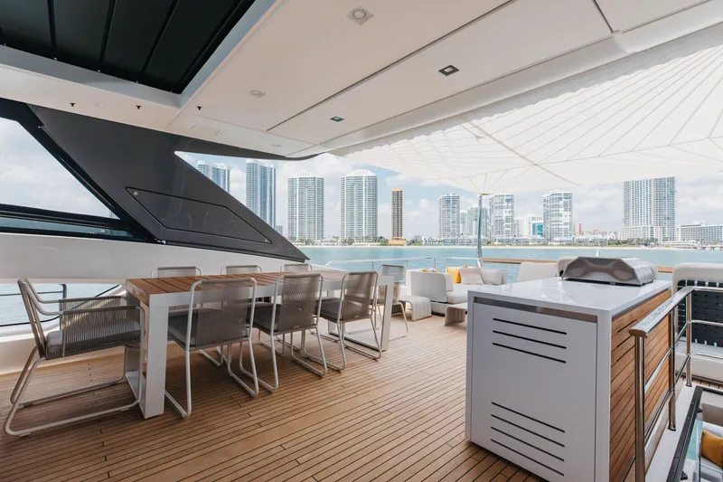 Slide: The Image of Luxurious 2024 Sanlorenzo SL90A yacht deck with modern seating and city skyline view. - 88