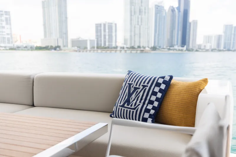 Slide: The Image of Luxury yacht Sanlorenzo SL90A 2024 with stylish cushions, city skyline in background. - 75
