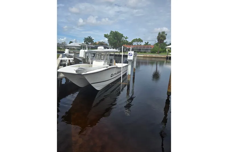 The Image of 2019 AmeraCat Ameracat 27 boat docked in a serene marina setting. - 1