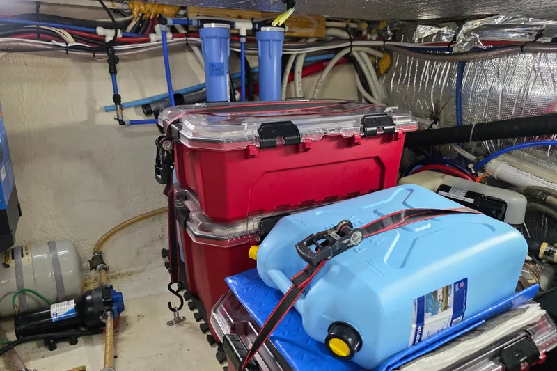 Slide: The Image of Engine room of 2001 Cruisers Yachts 4450 Express Motoryacht with storage containers and equipment. - 21