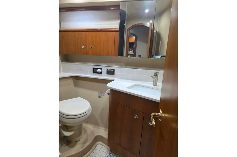 Slide: The Image of Luxurious bathroom in 2001 Cruisers Yachts 4450 Express Motoryacht with wood cabinetry and modern fixtures. - 18