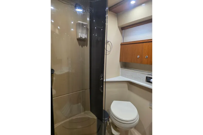 Slide: The Image of Luxurious bathroom in 2001 Cruisers Yachts 4450 Express Motoryacht with shower and wooden cabinetry. - 17