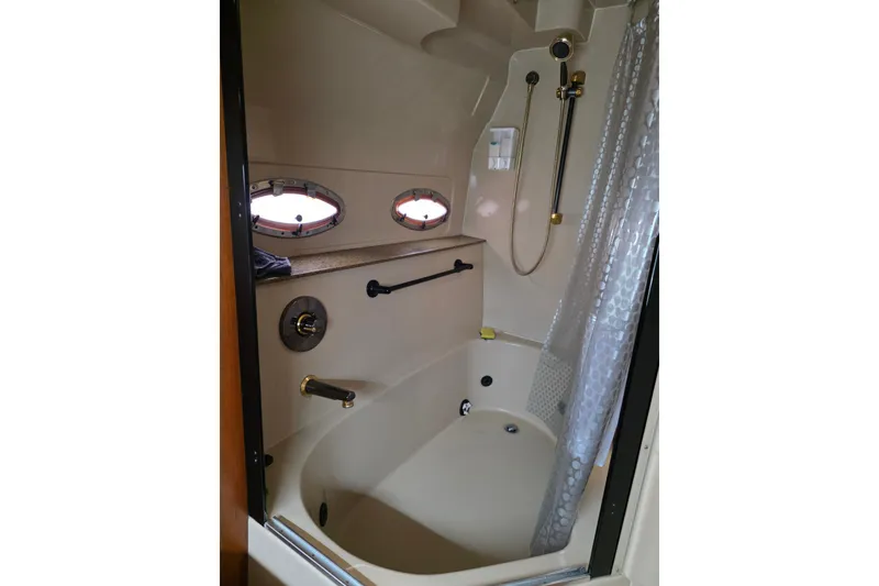 Slide: The Image of Luxurious bathroom in 2001 Cruisers Yachts 4450 Express Motoryacht with shower and porthole windows. - 16