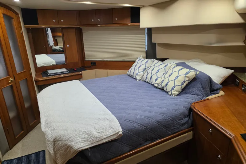 Slide: The Image of Luxurious bedroom interior of 2001 Cruisers Yachts 4450 Express Motoryacht with cozy bedding. - 13