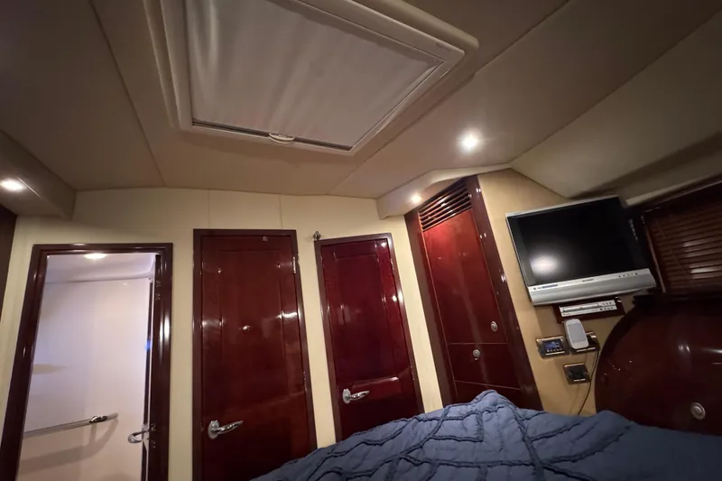Slide: The Image of Luxurious interior of 2007 Sea Ray 58 Sedan Bridge with wood finishes and mounted TV. - 34