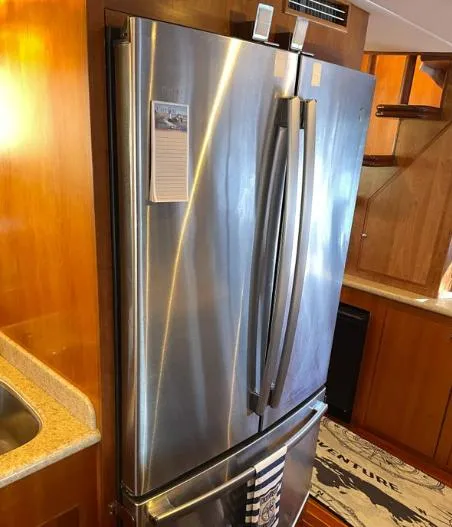 Slide: The Image of Stainless steel refrigerator in 2002 Grand Alaskan Cockpit Motor Yacht kitchen interior. - 25