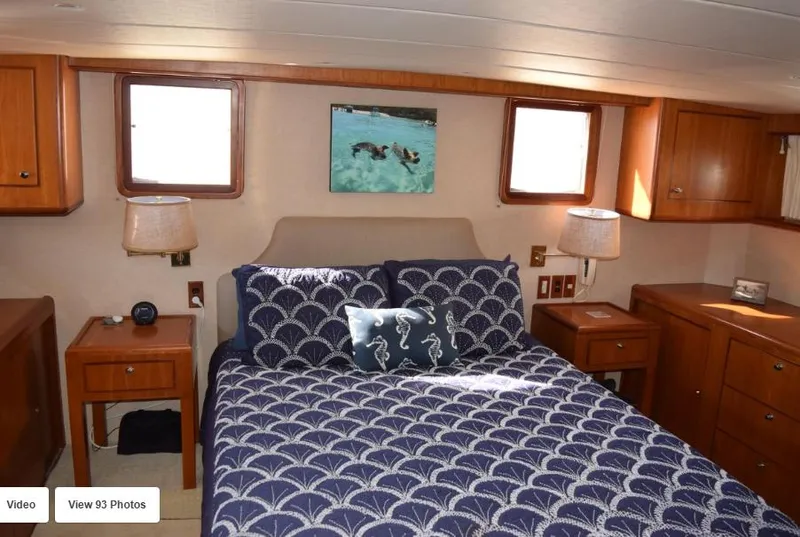 Slide: The Image of Luxurious bedroom interior of 2002 Grand Alaskan Cockpit Motor Yacht with nautical-themed bedding. - 31