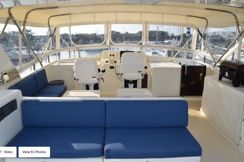 Slide: The Image of 2002 Grand Alaskan Cockpit Motor Yacht interior with blue seating and helm station. - 5