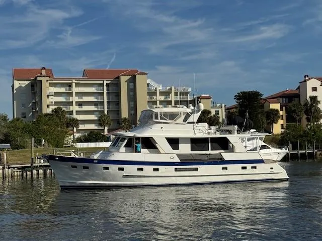 The Image of 2002 Grand Alaskan Cockpit Motor Yacht docked near waterfront buildings. - 0