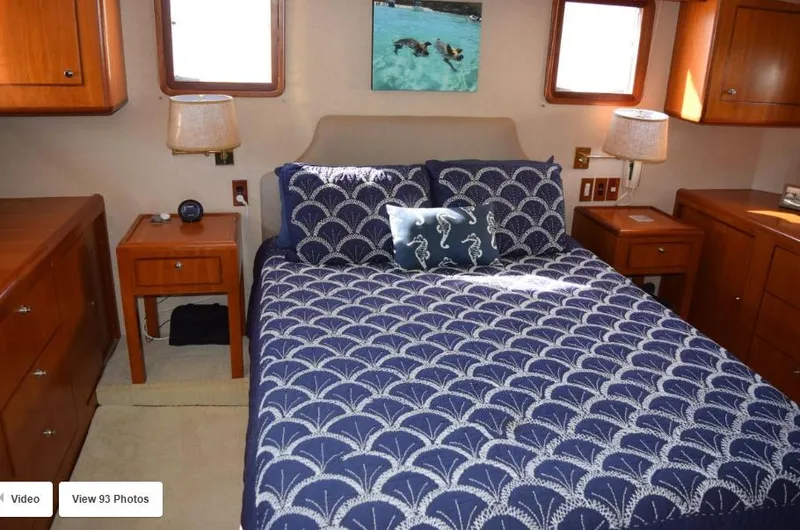 Slide: The Image of Luxurious bedroom in 2002 Grand Alaskan Cockpit Motor Yacht with nautical-themed bedding. - 32