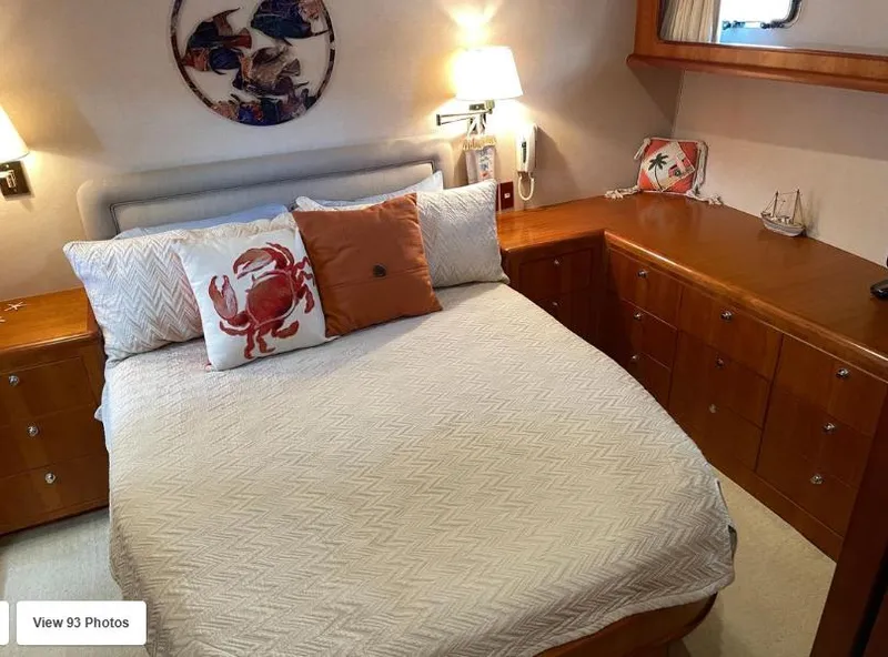 Slide: The Image of Cozy bedroom in 2002 Grand Alaskan Cockpit Motor Yacht with nautical decor and wooden cabinetry. - 40