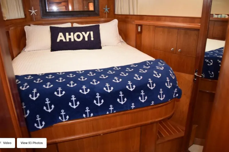 Slide: The Image of Cozy bedroom in 2002 Grand Alaskan Cockpit Motor Yacht with nautical decor and "Ahoy" pillow. - 47