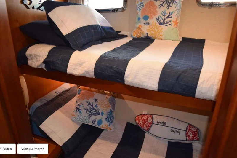 Slide: The Image of Bunk beds with nautical-themed bedding in 2002 Grand Alaskan Cockpit Motor Yacht cabin. - 46