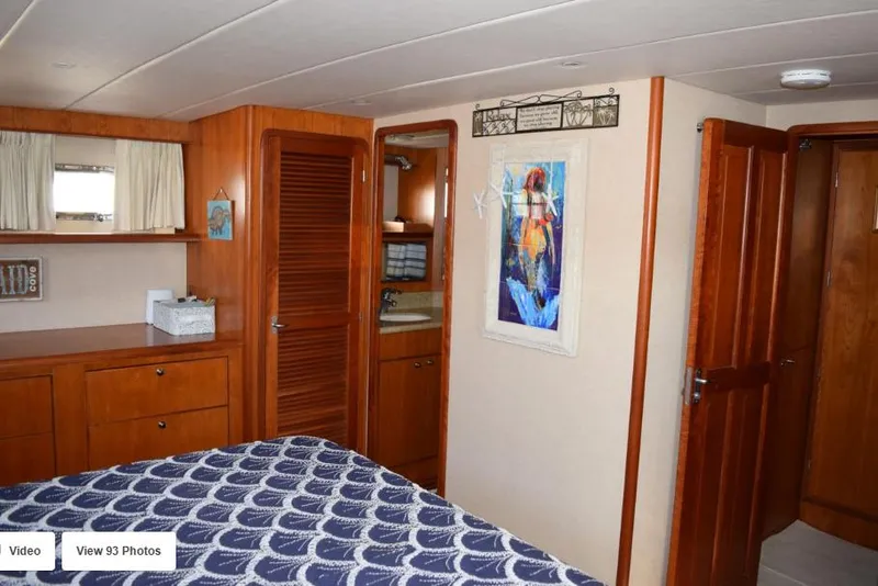 Slide: The Image of 2002 Grand Alaskan Cockpit Motor Yacht interior with wood cabinetry and nautical-themed decor. - 36