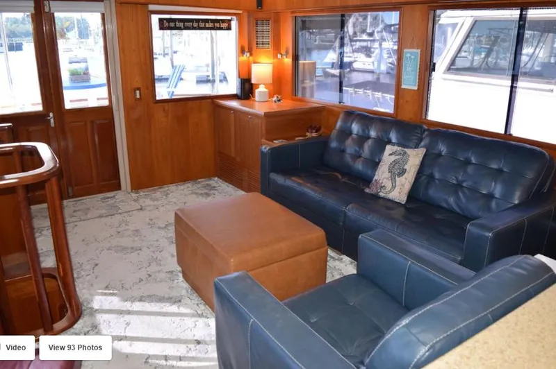 Slide: The Image of Luxurious 2002 Grand Alaskan Cockpit Motor Yacht interior with blue leather seating and wood accents. - 13