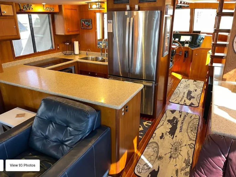 Slide: The Image of Luxurious 2002 Grand Alaskan Cockpit Motor Yacht interior with modern kitchen and seating area. - 22