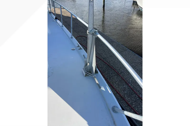 Slide: The Image of 1999 Viking 60 CPMY yacht deck with railing, docked by the water. - 25