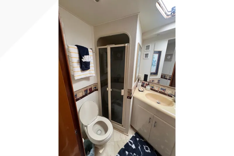 Slide: The Image of Bathroom interior of 1999 Viking 60 CPMY yacht with shower and sink. - 81