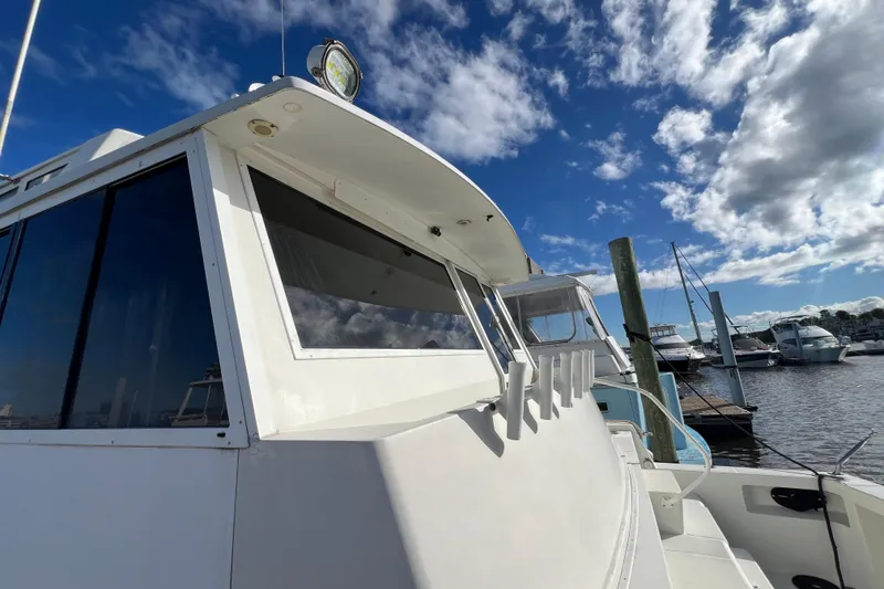 Slide: The Image of 1999 Viking 60 CPMY yacht docked under a partly cloudy sky. - 17