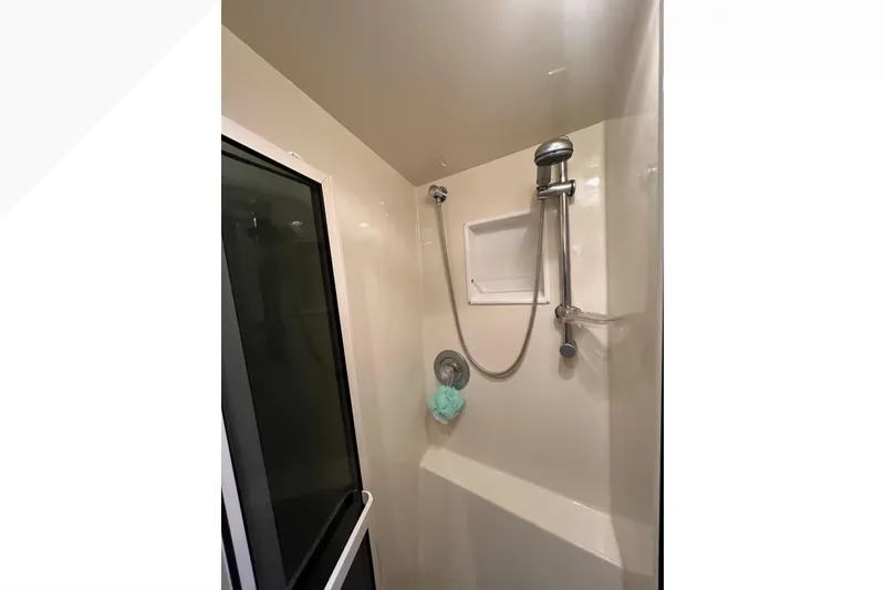 Slide: The Image of Shower area in 1999 Viking 60 CPMY yacht with handheld showerhead and glass door. - 92