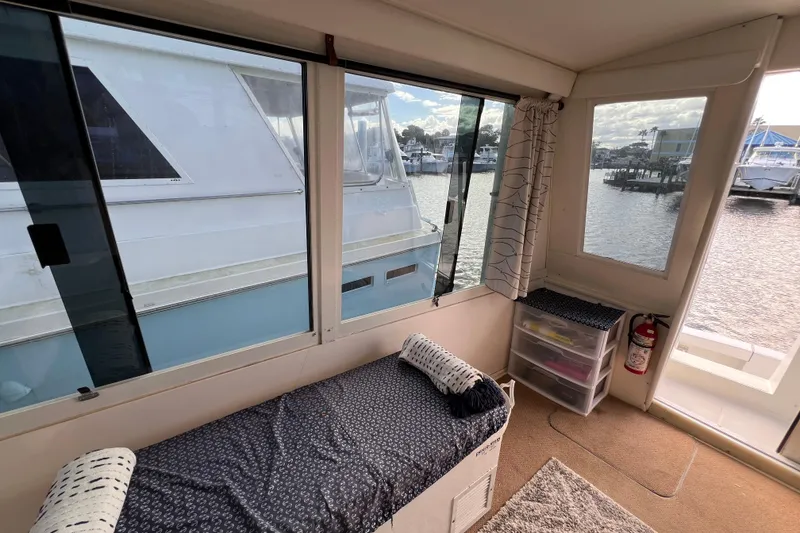Slide: The Image of Interior view of a 1999 Viking 60 CPMY yacht with marina backdrop. - 30