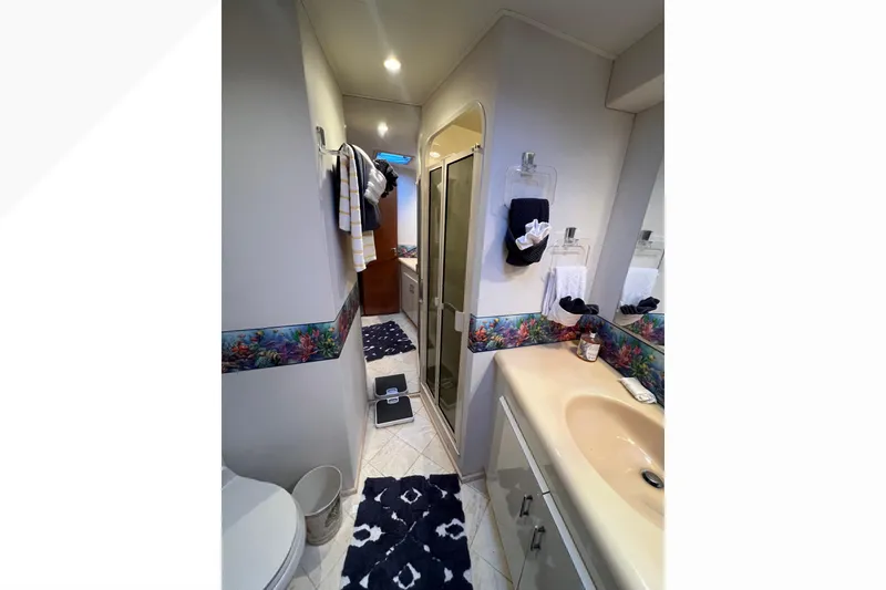 Slide: The Image of Bathroom interior of 1999 Viking 60 CPMY yacht with sink, shower, and decorative accents. - 90