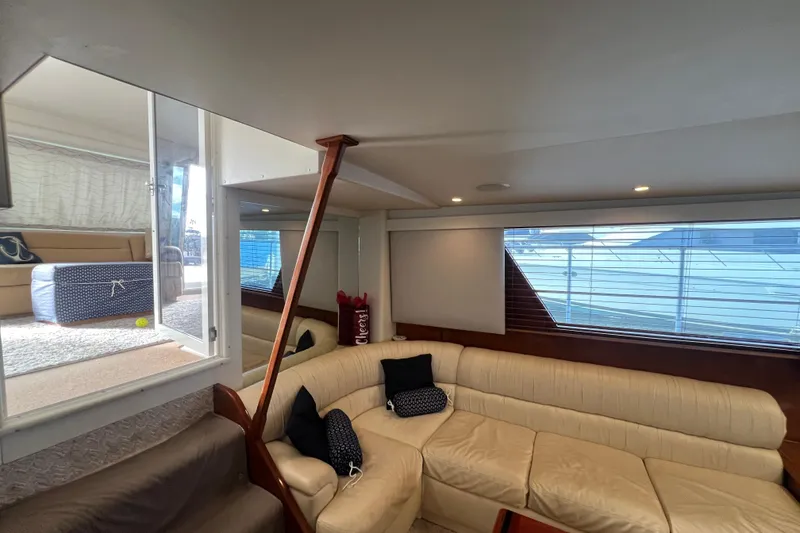 Slide: The Image of Luxurious interior of 1999 Viking 60 CPMY yacht with beige seating and nautical decor. - 66