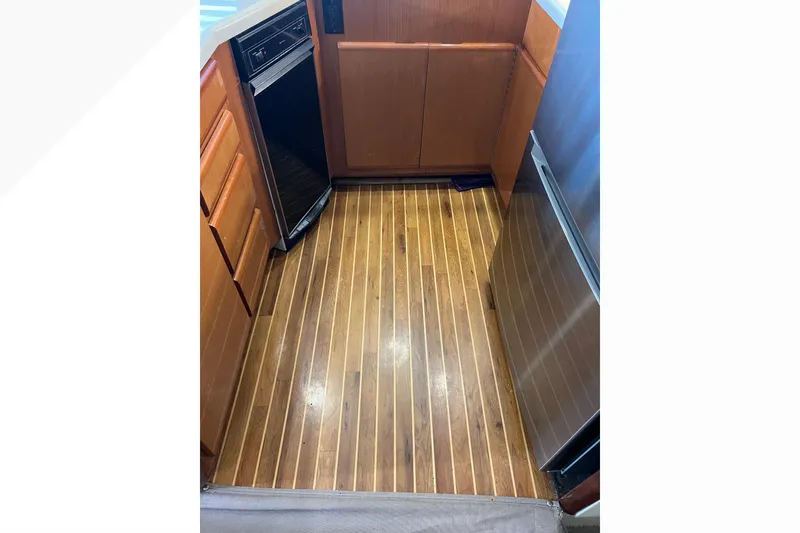 Slide: The Image of Wooden galley floor in 1999 Viking 60 CPMY yacht kitchen area. - 70