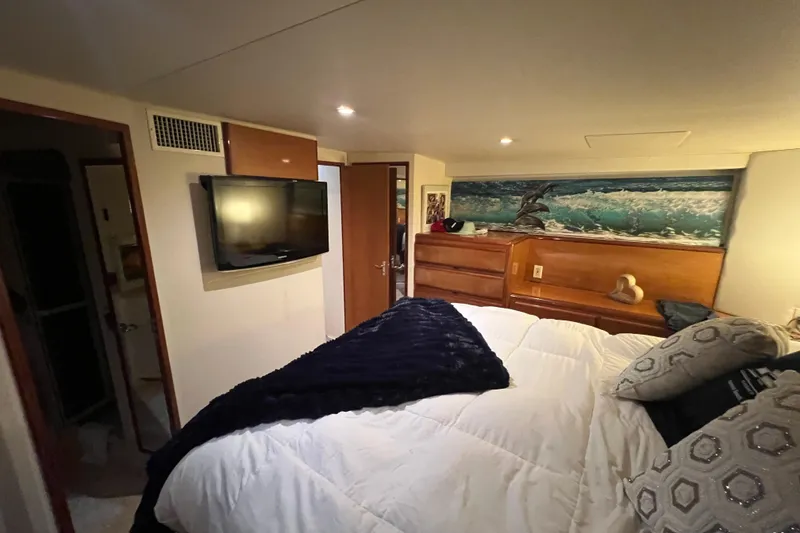 Slide: The Image of Luxurious bedroom interior of 1999 Viking 60 CPMY yacht with modern amenities. - 98