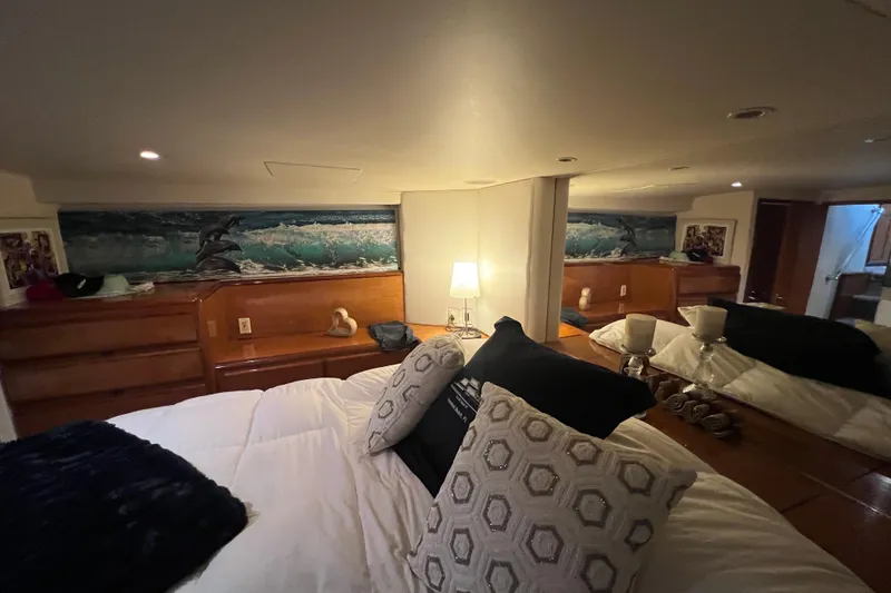 Slide: The Image of Cozy bedroom interior of 1999 Viking 60 CPMY yacht with decorative pillows and artwork. - 97