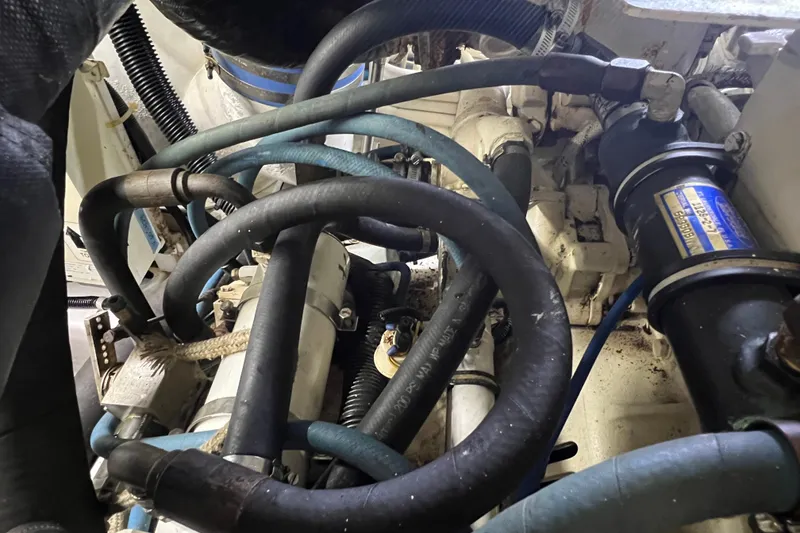 Slide: The Image of Engine compartment of a 1999 Viking 60 CPMY with hoses and mechanical components. - 131