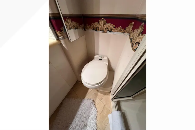 Slide: The Image of Bathroom in 1999 Viking 60 CPMY yacht with elegant wallpaper and modern toilet. - 112
