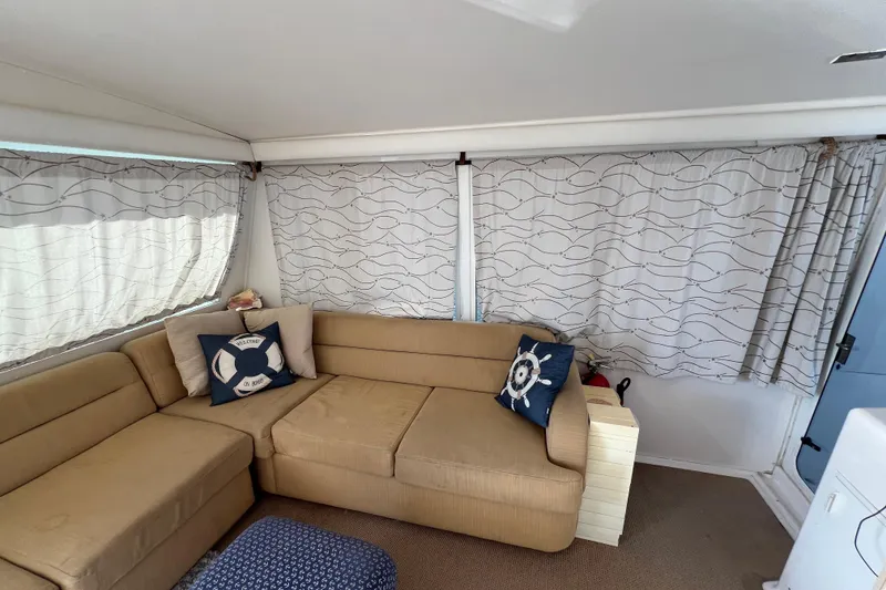 Slide: The Image of Interior of 1999 Viking 60 CPMY yacht with beige sofa and nautical-themed pillows. - 33