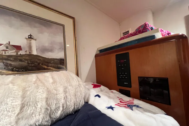 Slide: The Image of Cozy cabin interior of 1999 Viking 60 CPMY with lighthouse painting and control panel. - 80