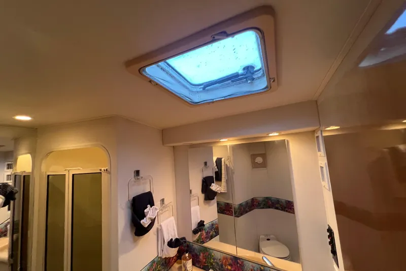 Slide: The Image of Bathroom interior of 1999 Viking 60 CPMY yacht with skylight and modern amenities. - 93
