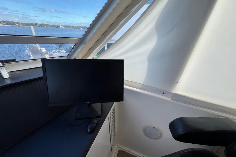 Slide: The Image of Interior of 1999 Viking 60 CPMY yacht with monitor and scenic water view. - 51